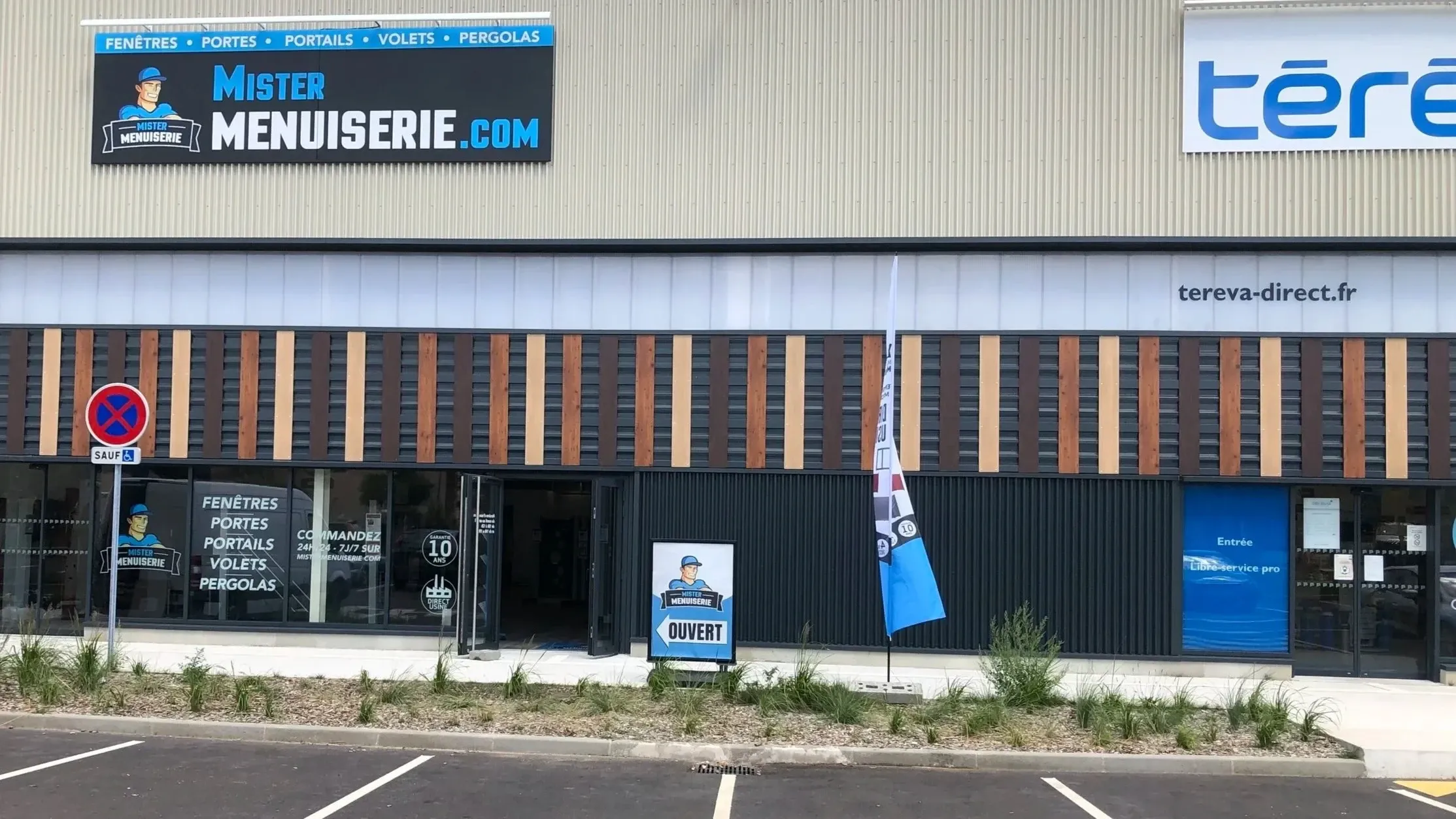 Façade et enseigne du showroom Mister Menuiserie après travaux, avec vitrophanie sur les vitrines